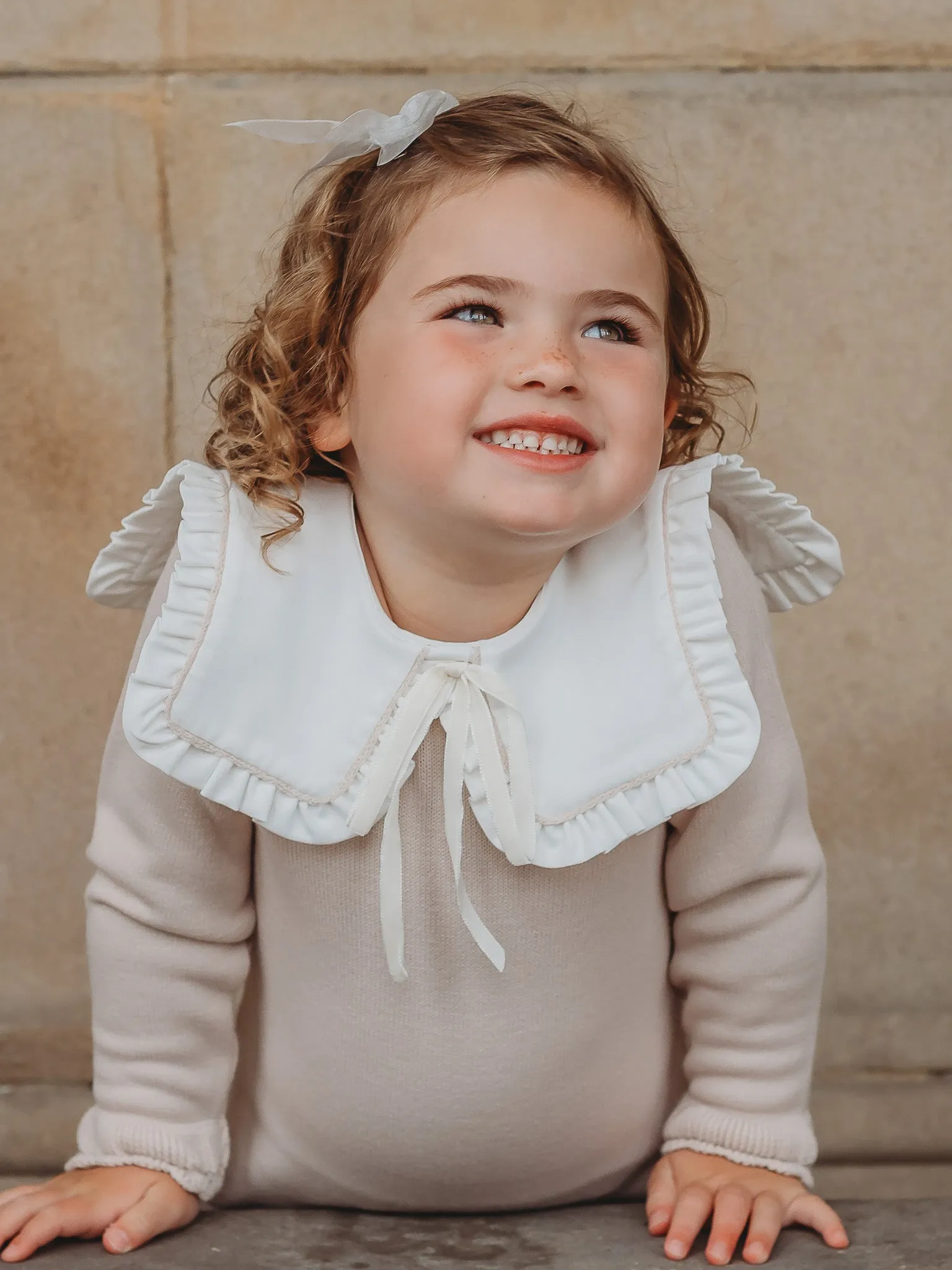 Baby Mabel beige knitted romper with bib collar